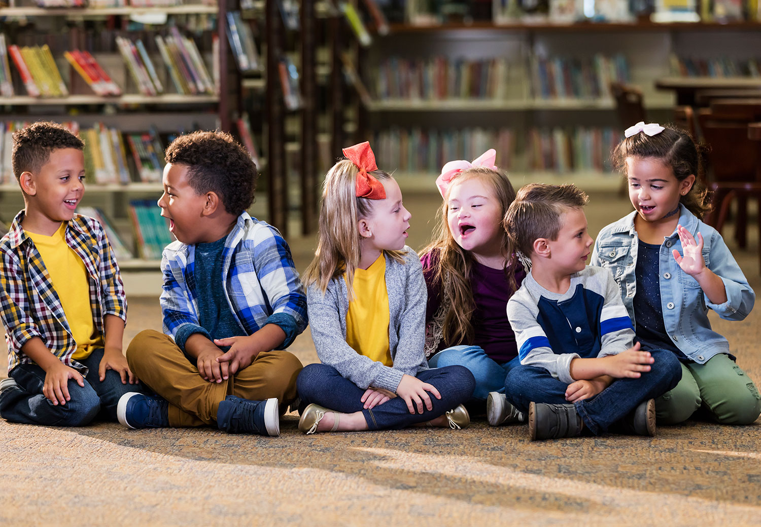 Children sitting together smiling